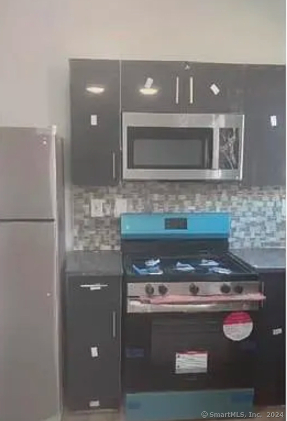 a stove top oven sitting inside of a kitchen