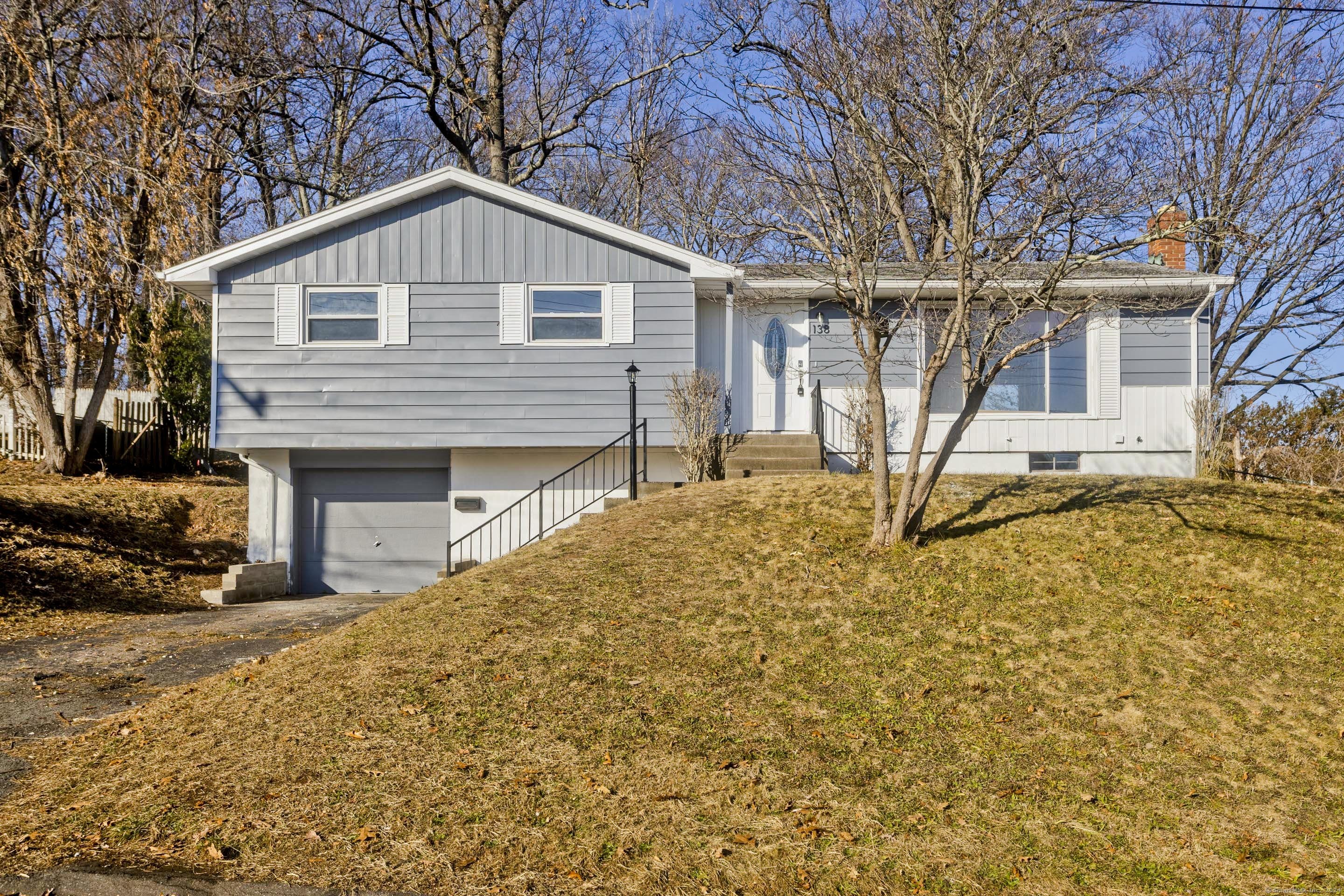 a front view of a house with a yard covered in snow