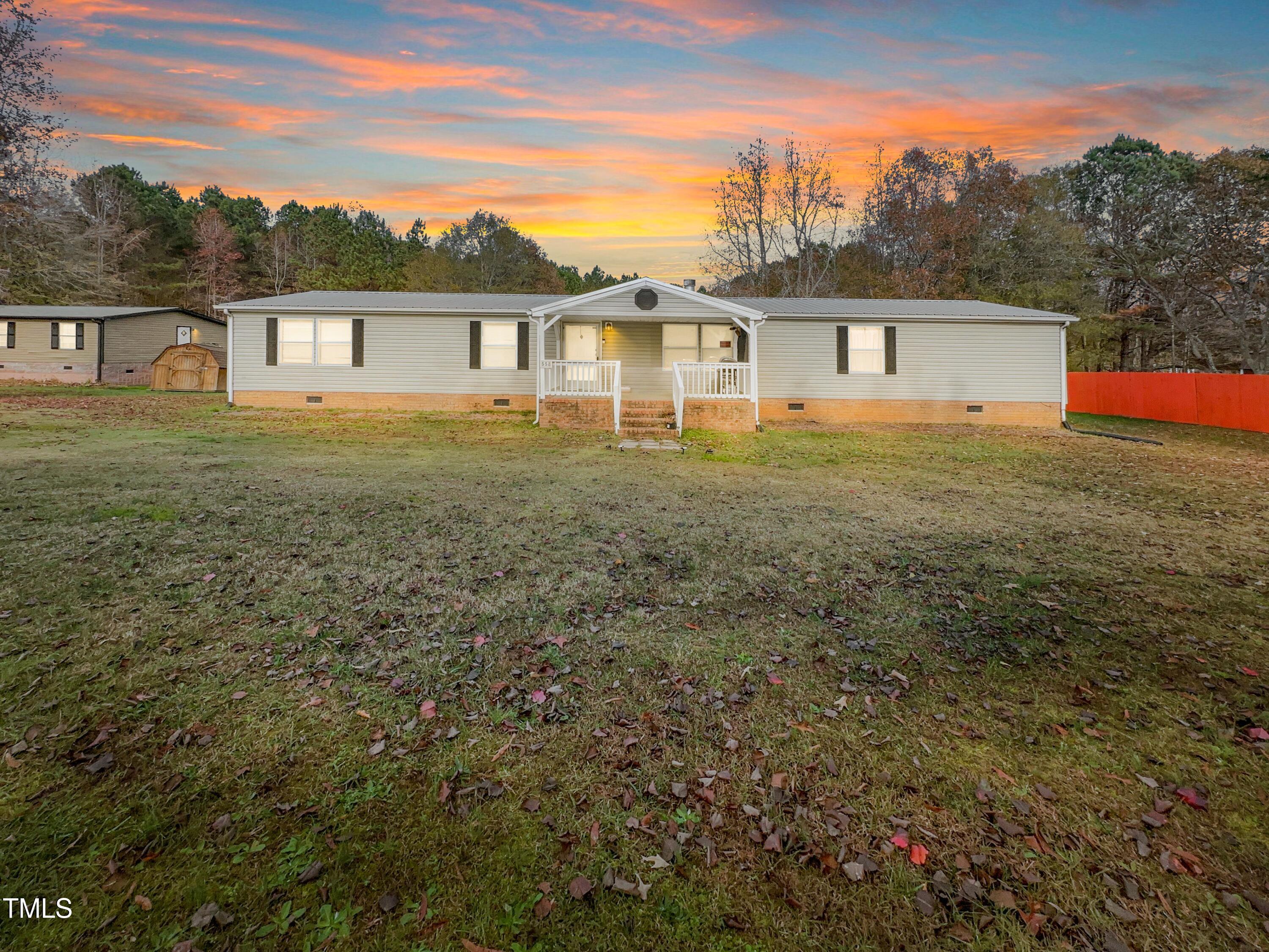 a view of a house with a backyard