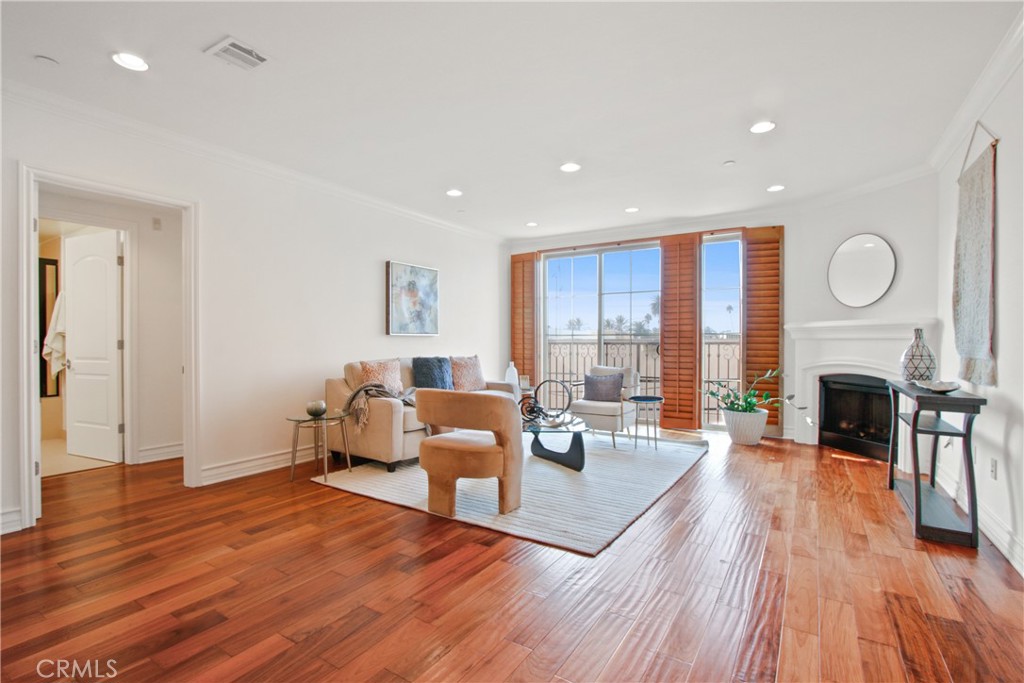 a living room with fireplace furniture wooden floor and a fireplace