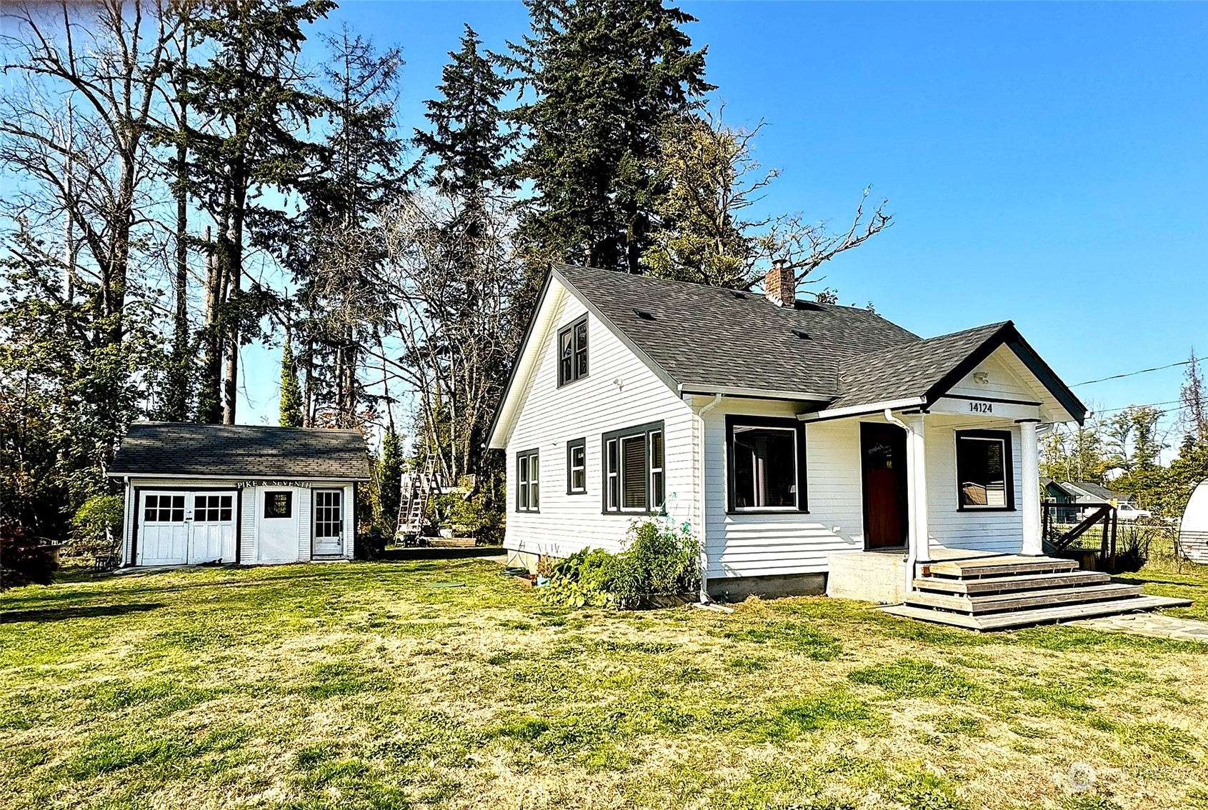 a front view of a house with a yard table and chairs