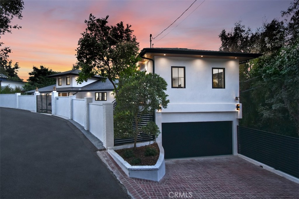 a front view of a house with yard and garage