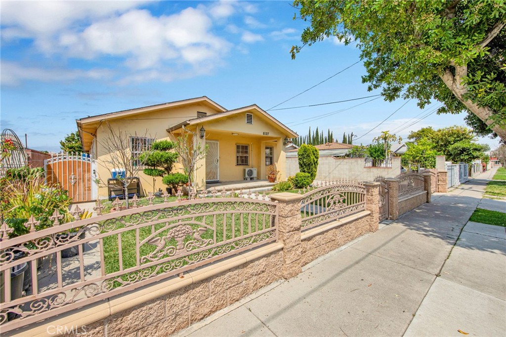 a front view of a house with a garden