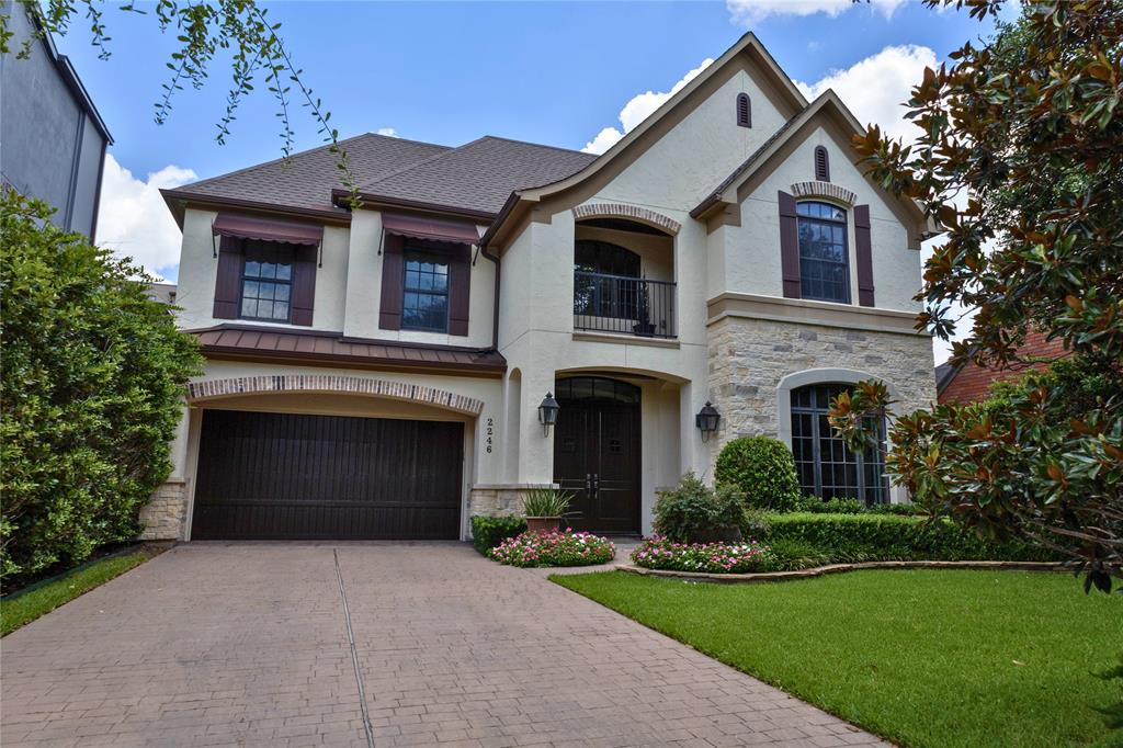 a front view of a house with a garden and yard