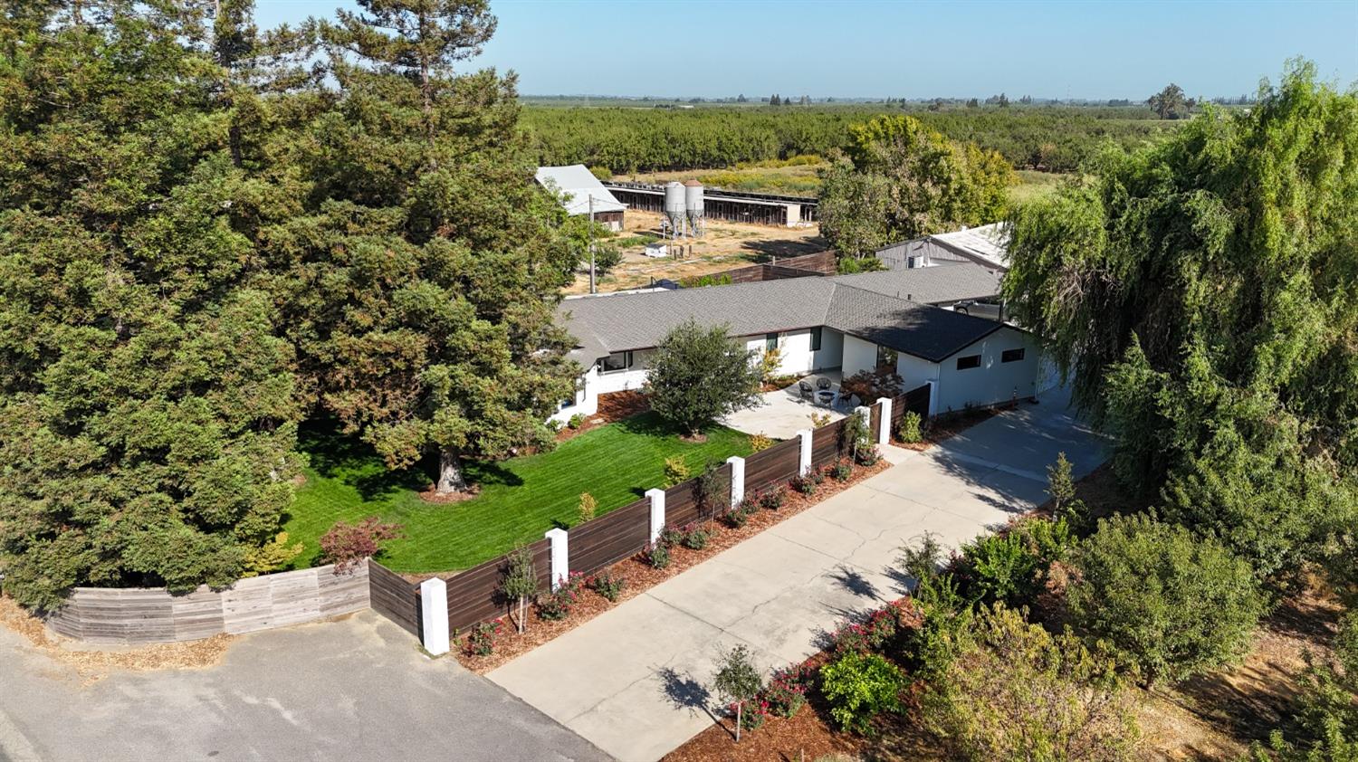 an aerial view of a house with a yard basket ball court and outdoor seating