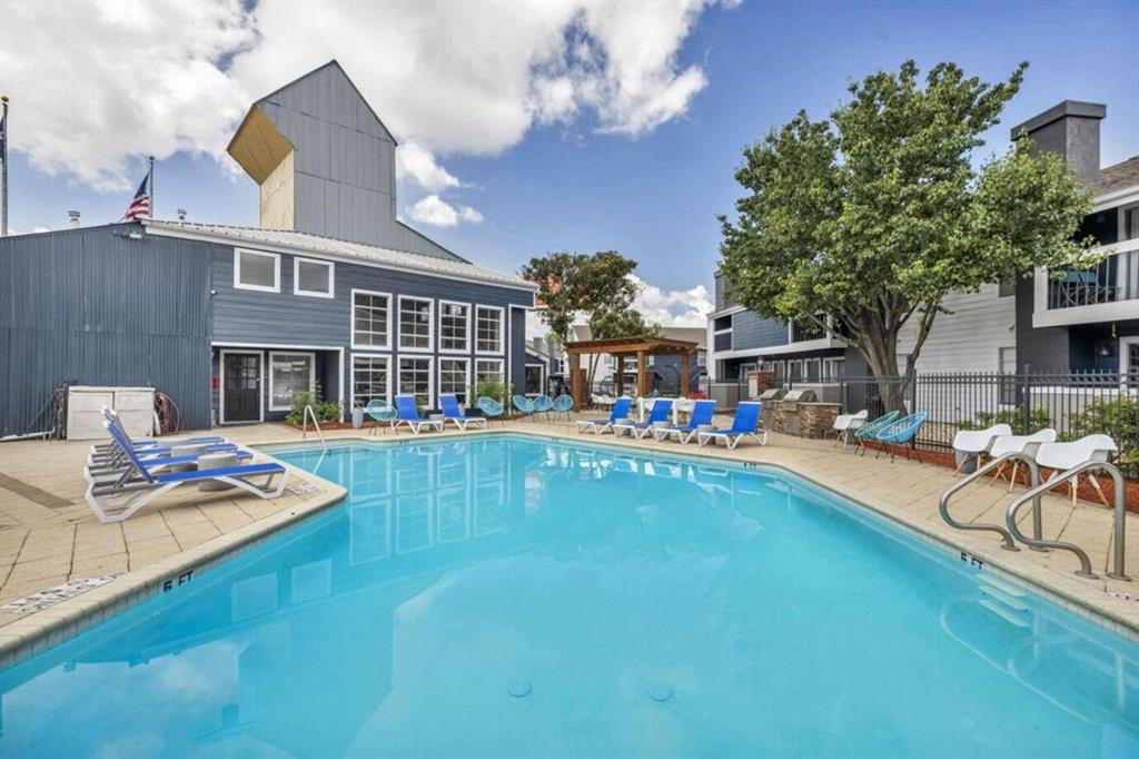 a front view of a house with swimming pool having outdoor seating