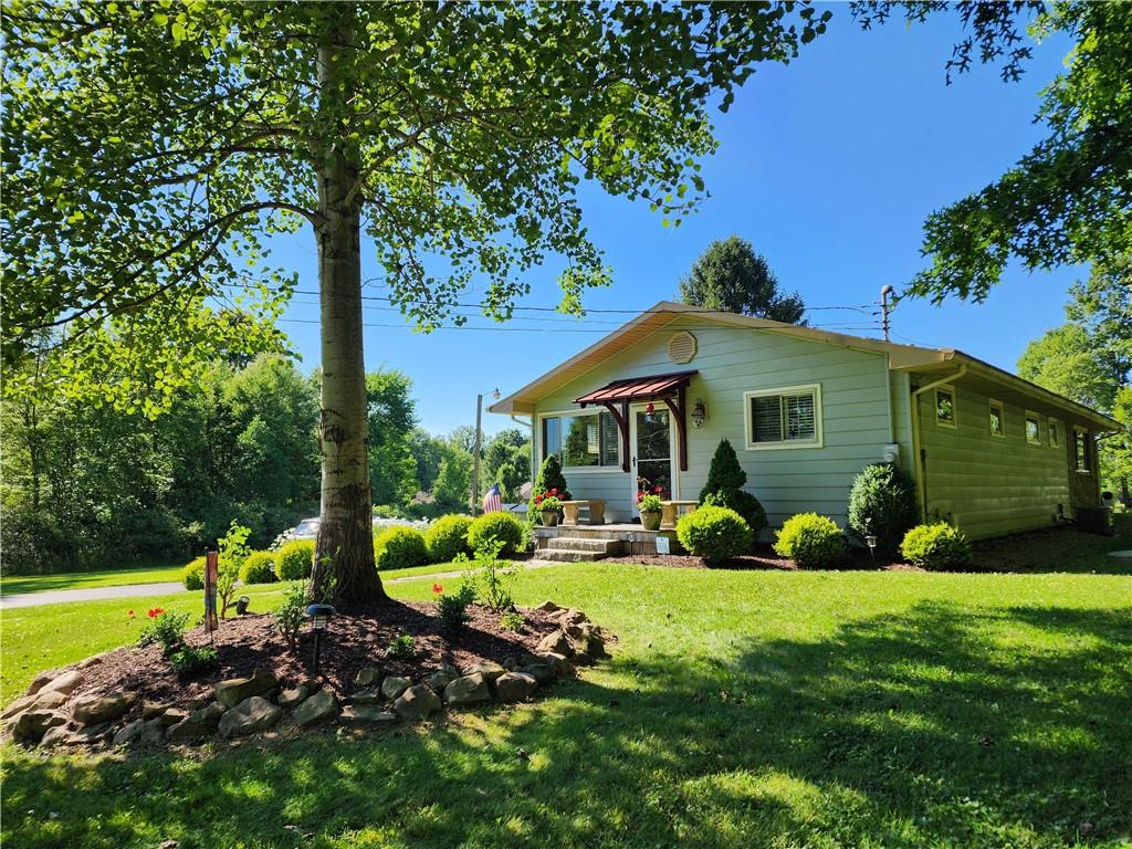 a view of a house with backyard sitting area and garden