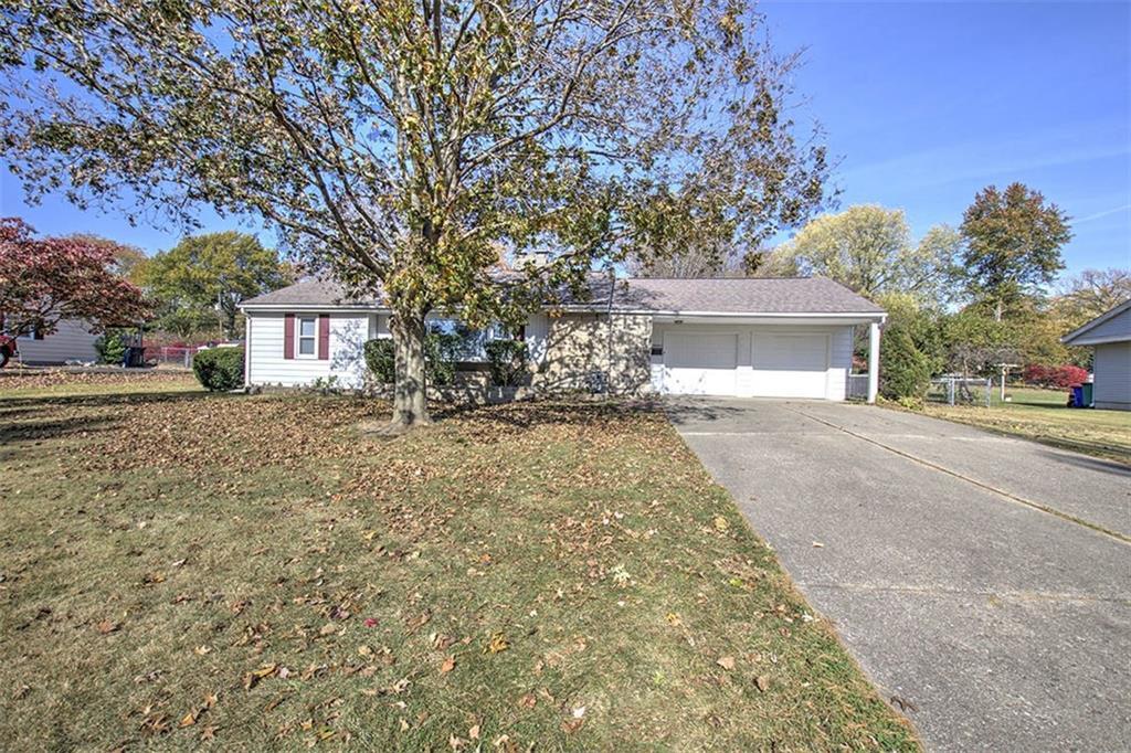 a view of a house with a yard and garage