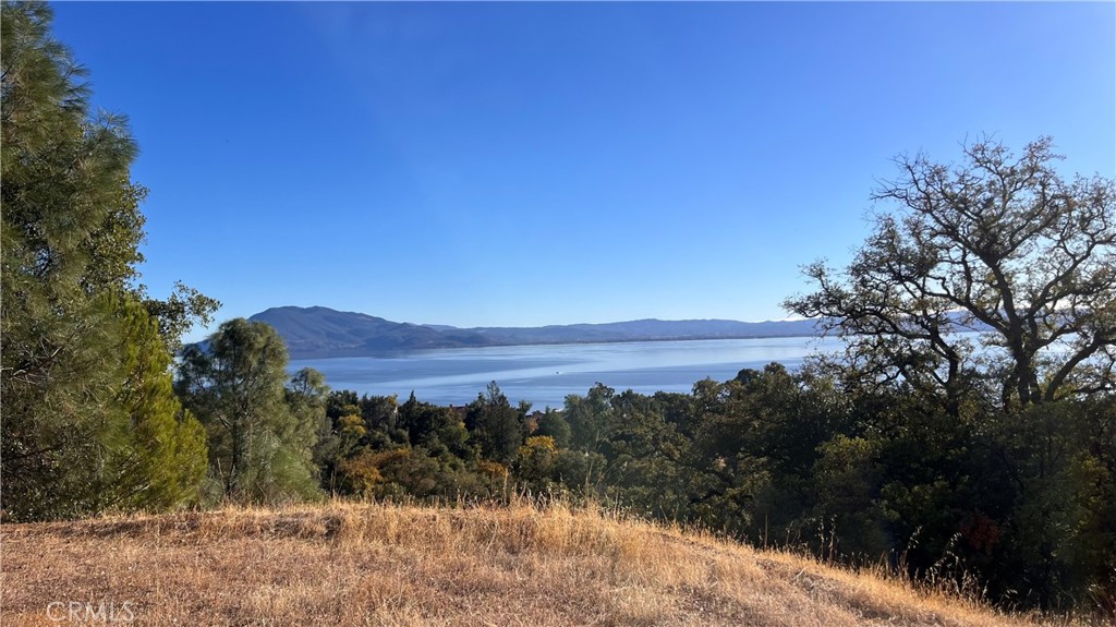 a view of mountain with lake in background