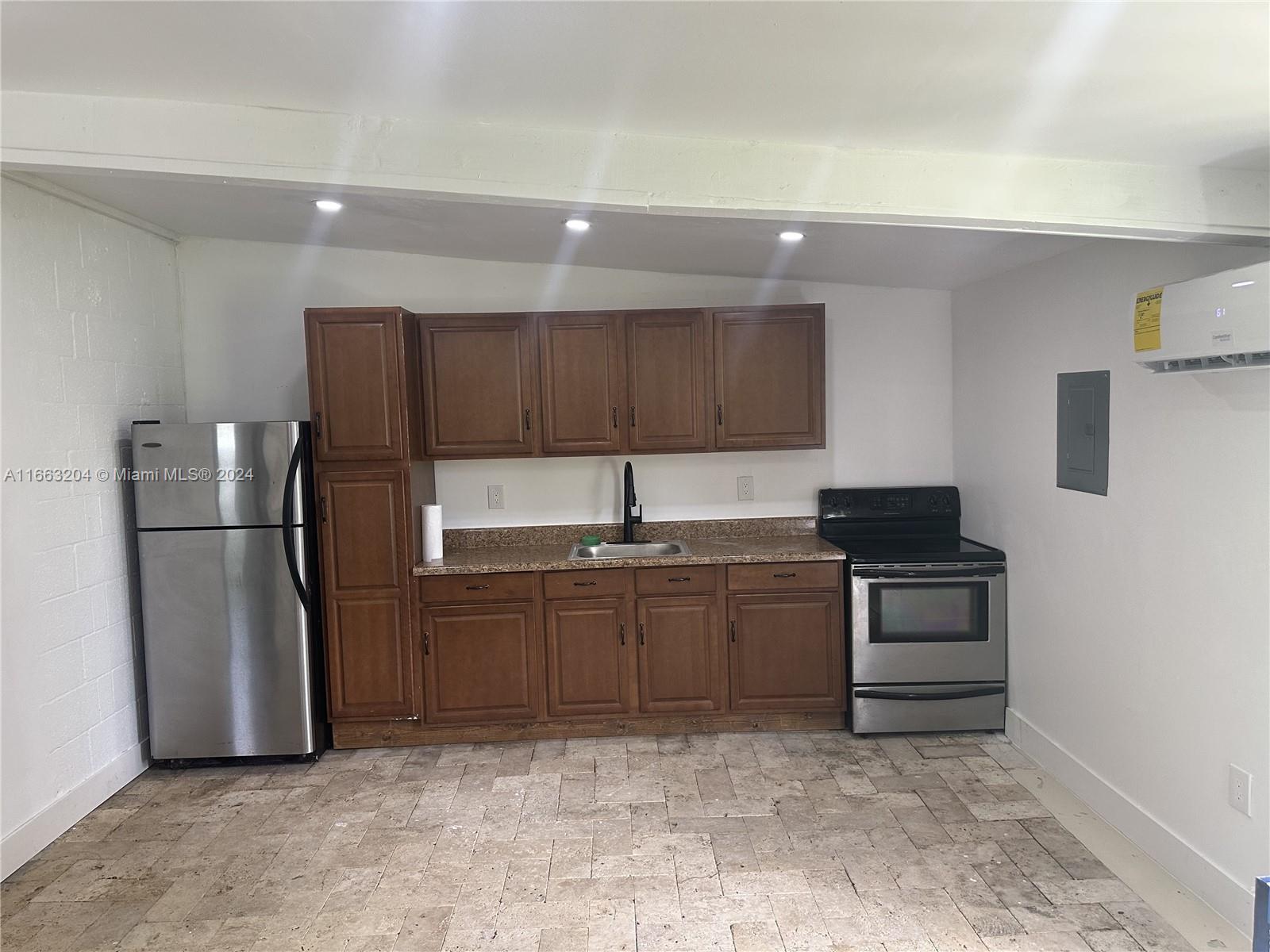 a kitchen with stainless steel appliances granite countertop a refrigerator and a sink