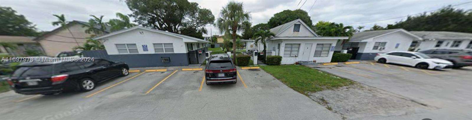 a view of house with outdoor space and parking