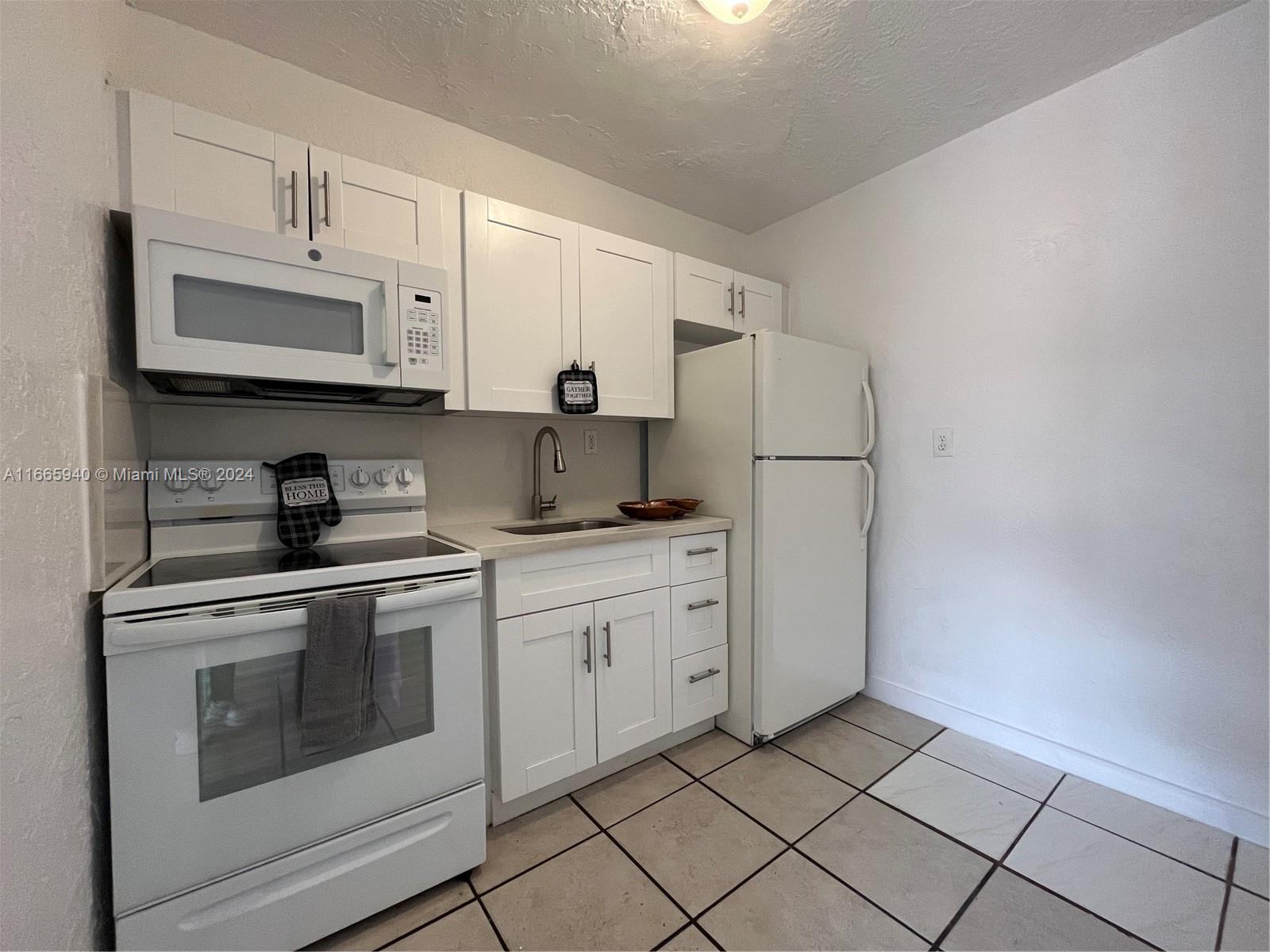 a kitchen with appliances cabinets and a sink