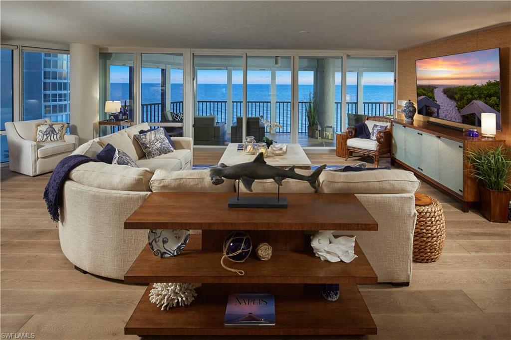 Living room featuring a wall of windows and light hardwood / wood-style flooring