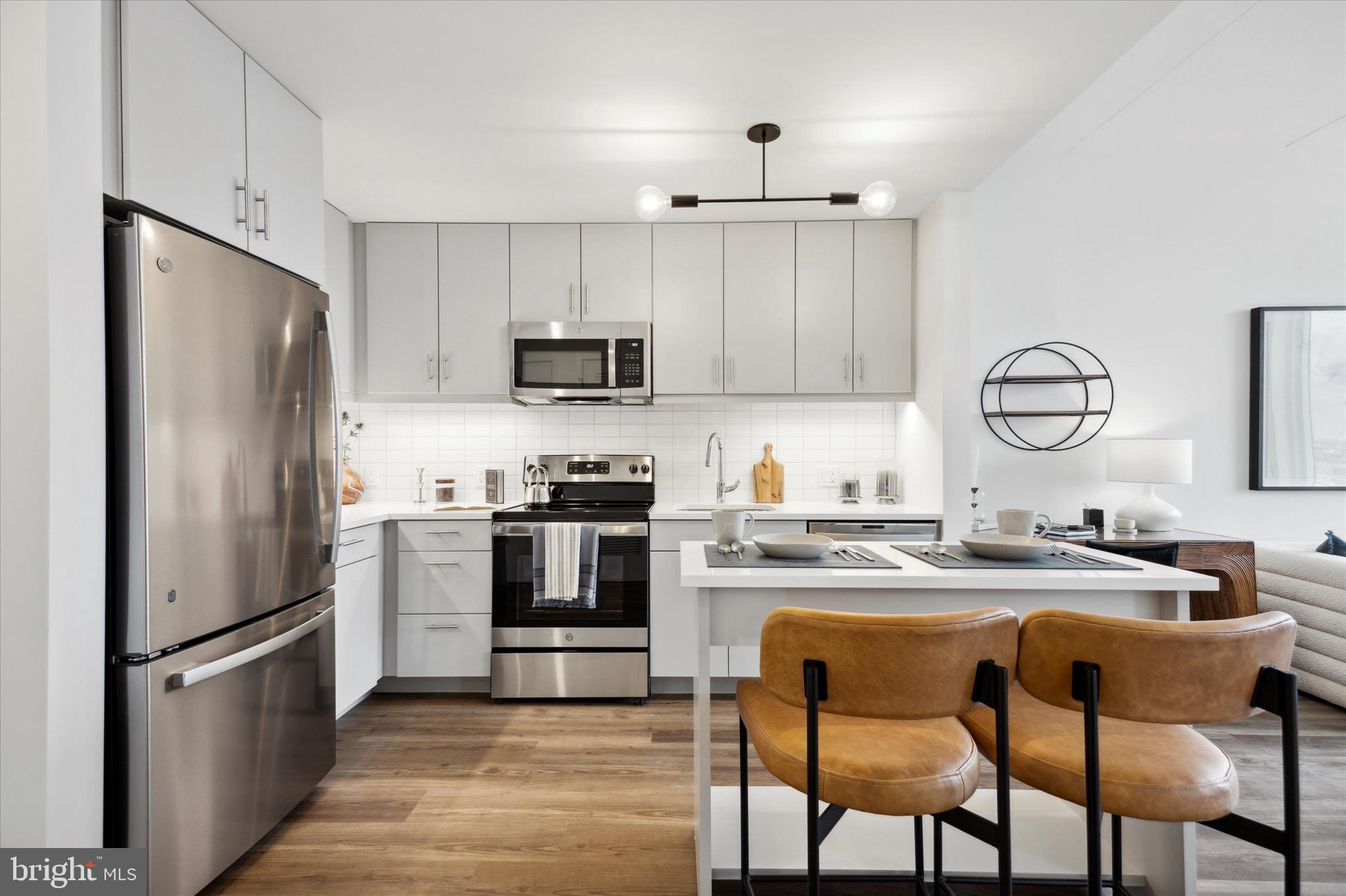 a kitchen with refrigerator cabinets and wooden floor