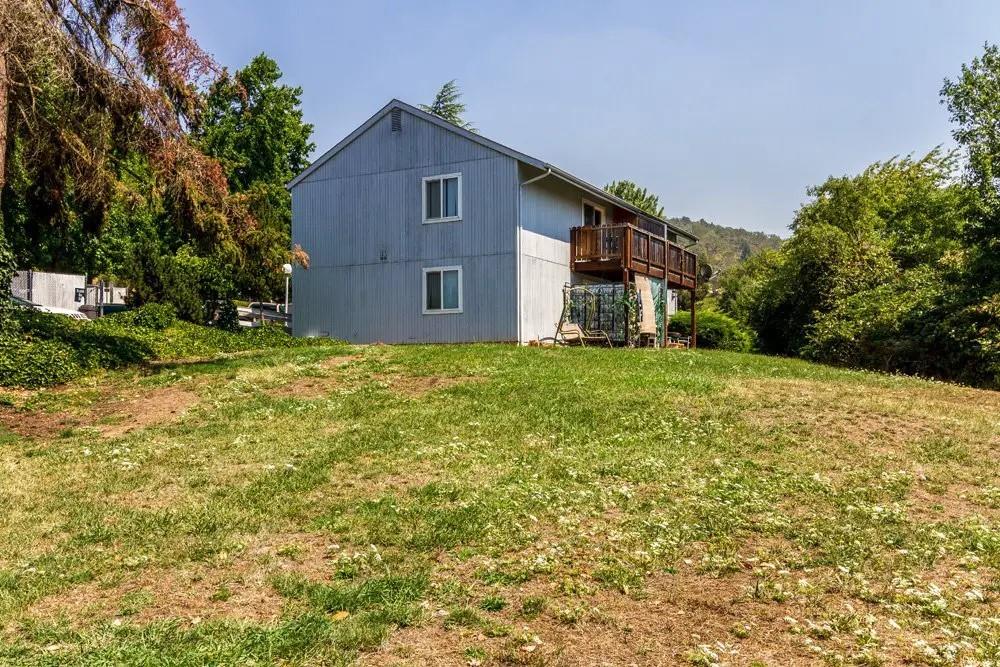 a house that has a tree in front of it