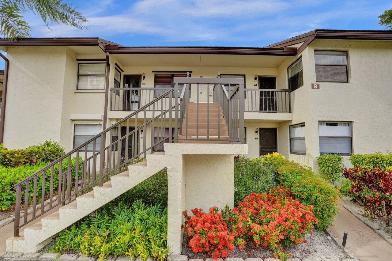 a front view of house along with deck and outdoor seating