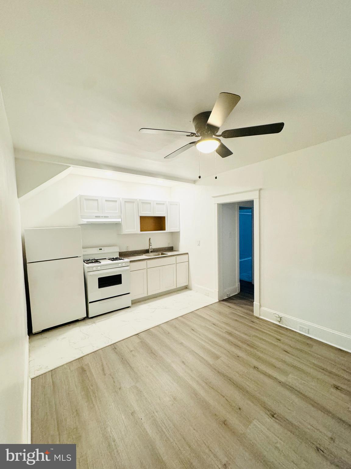 a view of a kitchen with microwave and cabinets