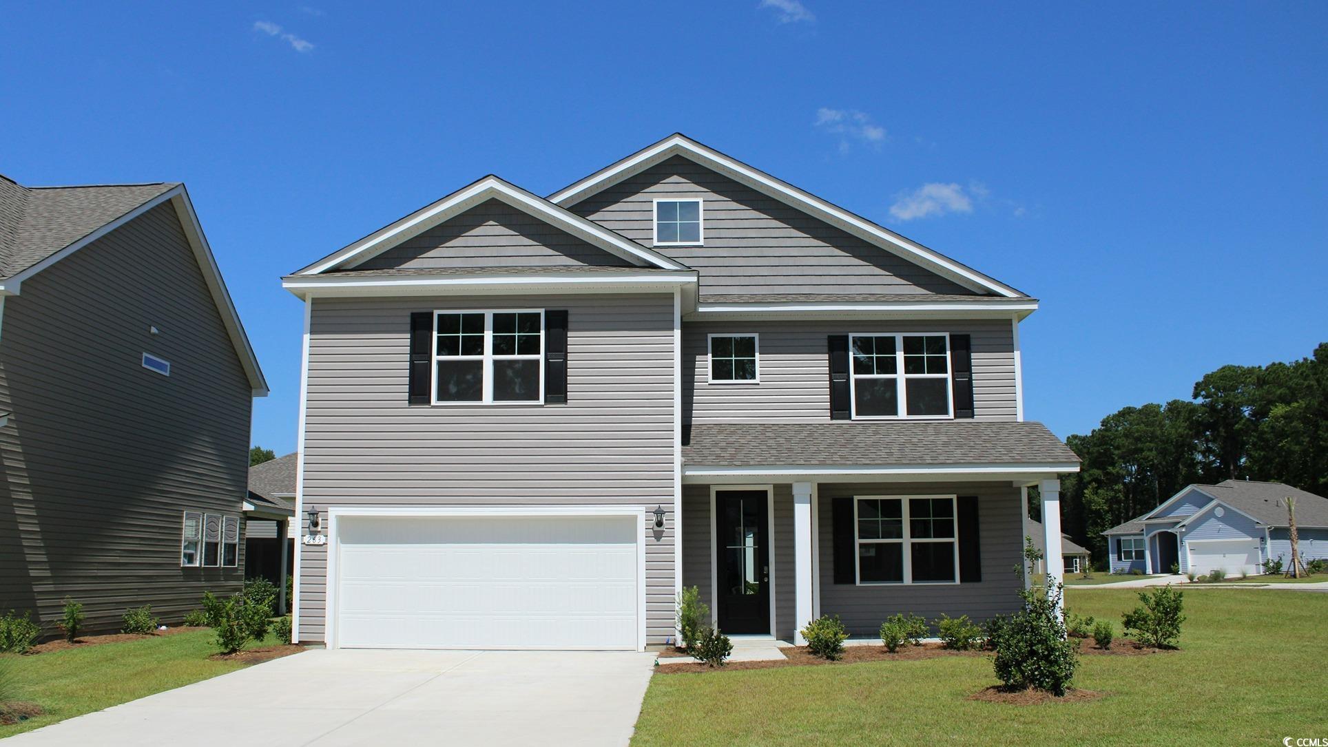 View of front facade featuring a front yard and a