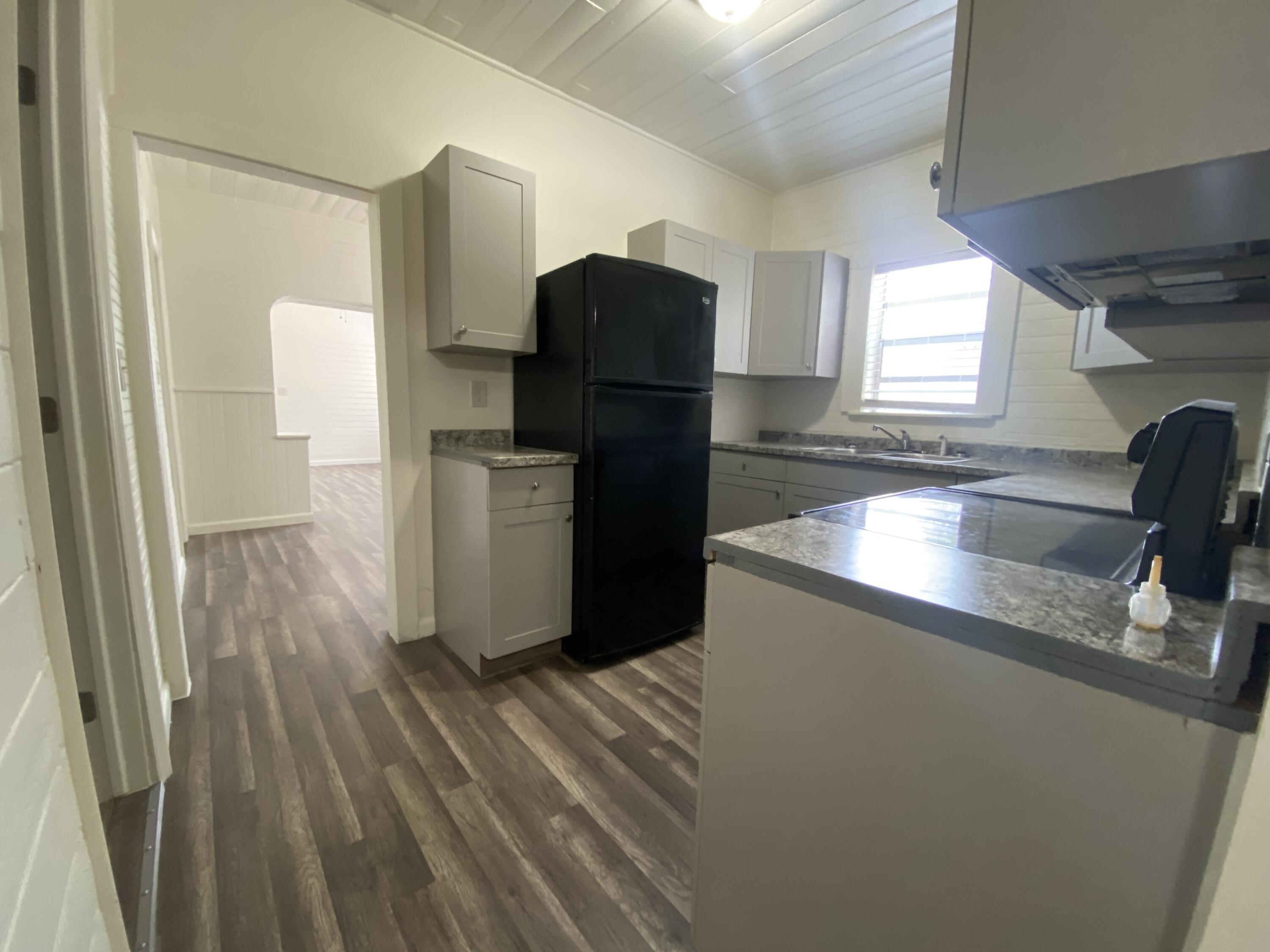 a kitchen with a refrigerator and a sink