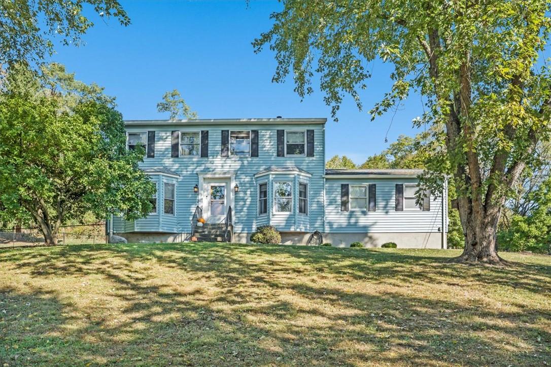 Colonial home featuring a front yard