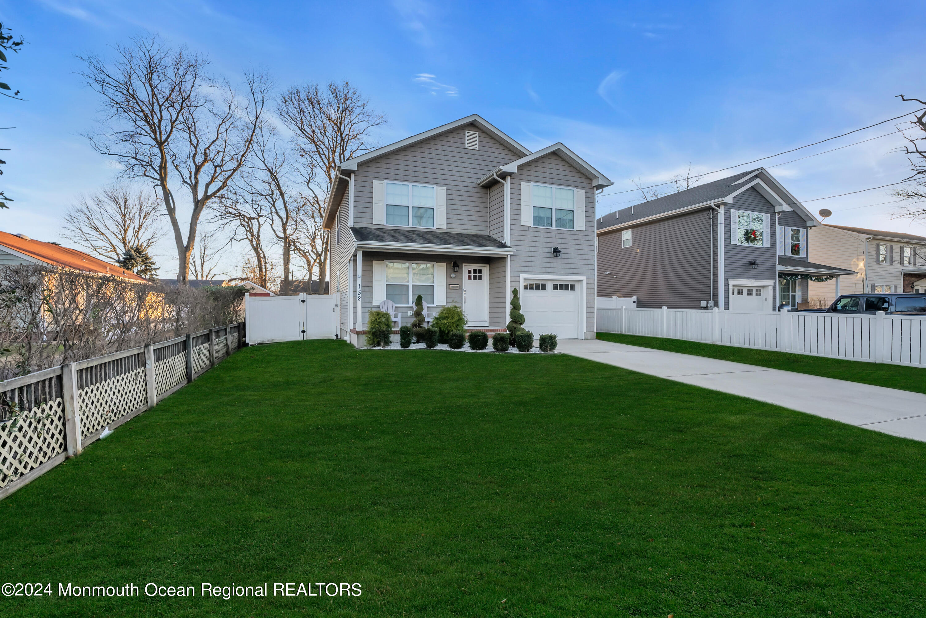 a front view of house with yard and green space