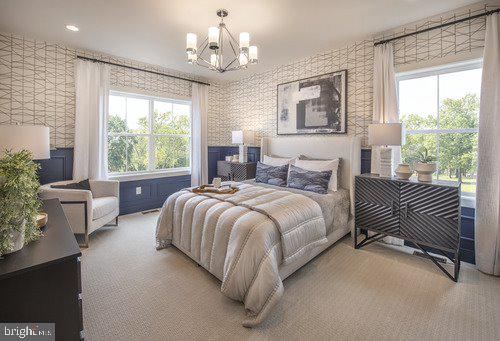 a spacious bedroom with a bed and a chandelier