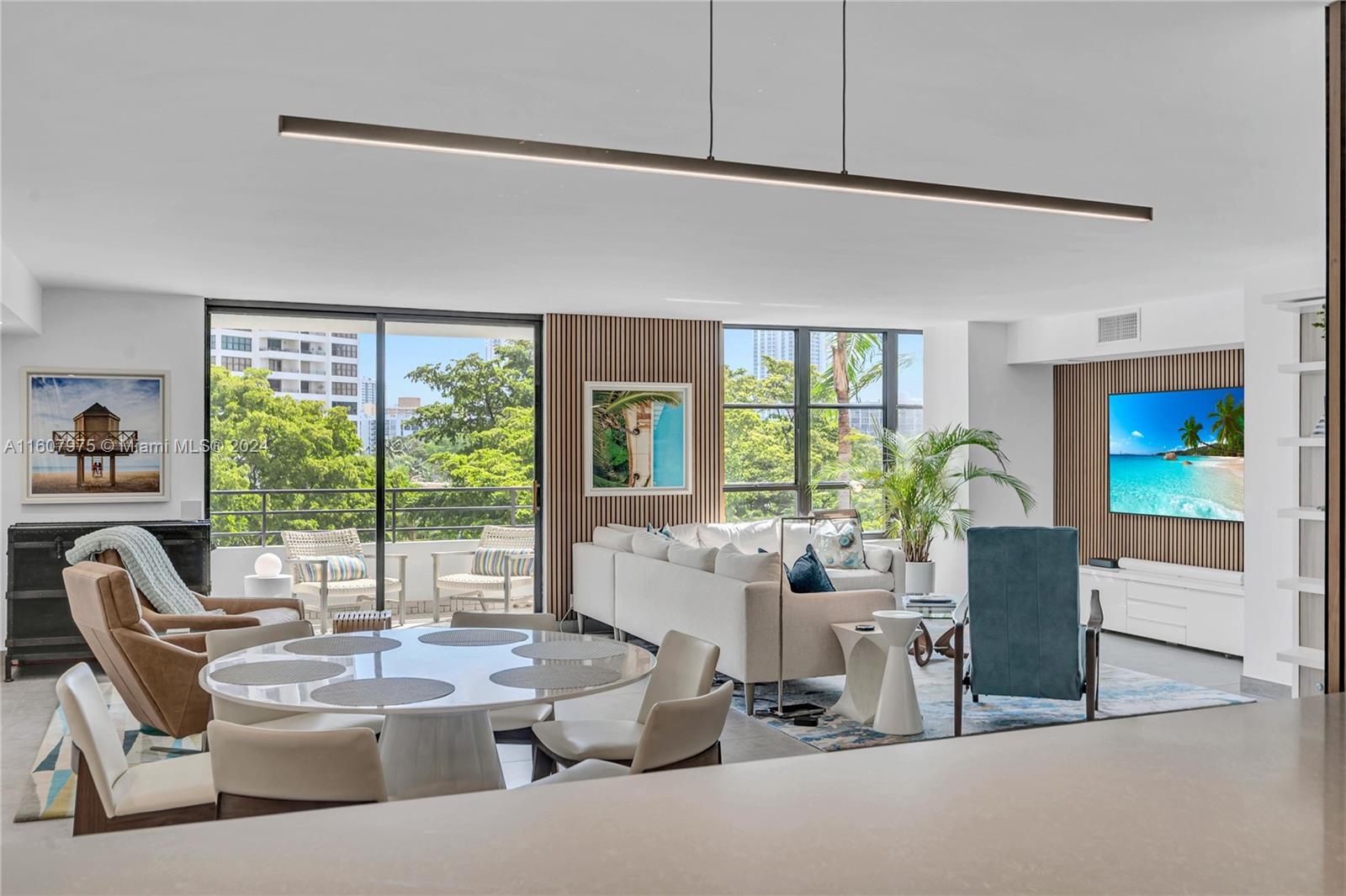 a dining room with furniture and large windows