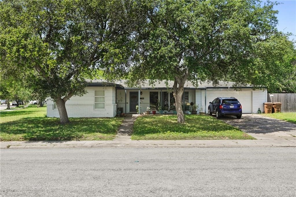 a front view of a house with a yard and a garage