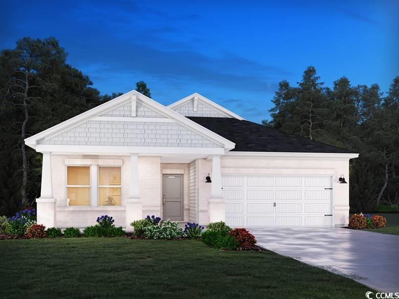 View of front of home with a garage and a lawn