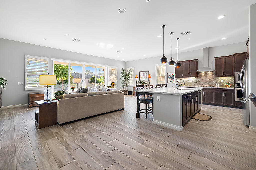 a living room with kitchen island furniture and a wooden floor