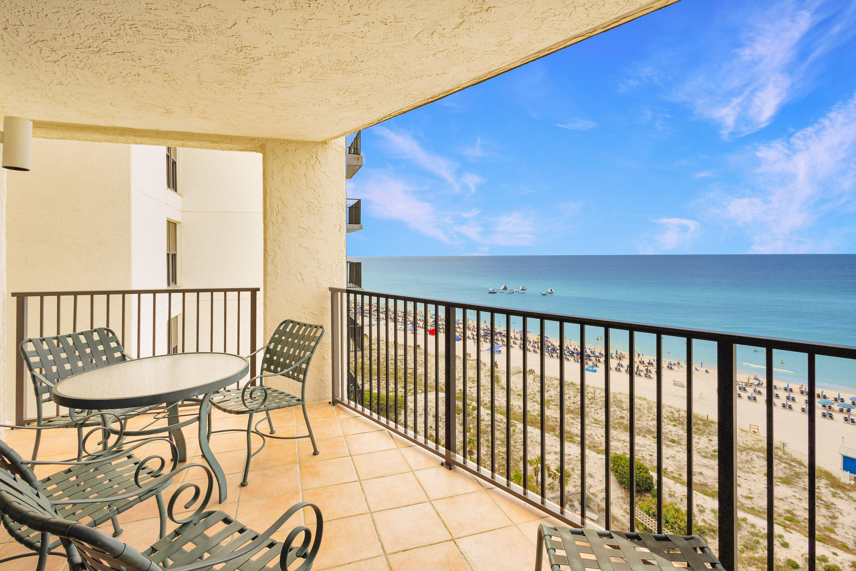 a balcony with table and chairs