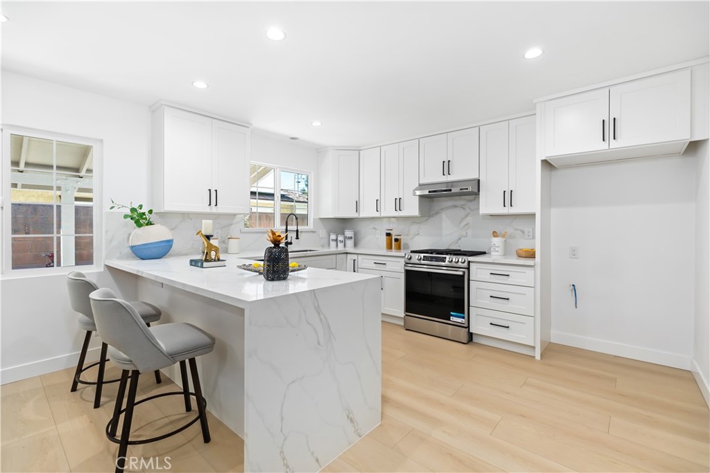 a kitchen with a stove a sink and a refrigerator