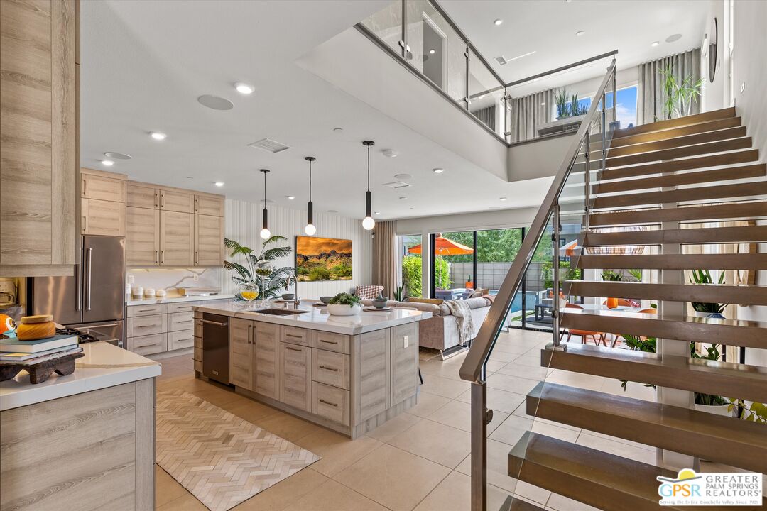 a kitchen with stainless steel appliances kitchen island granite countertop a stove and a refrigerator