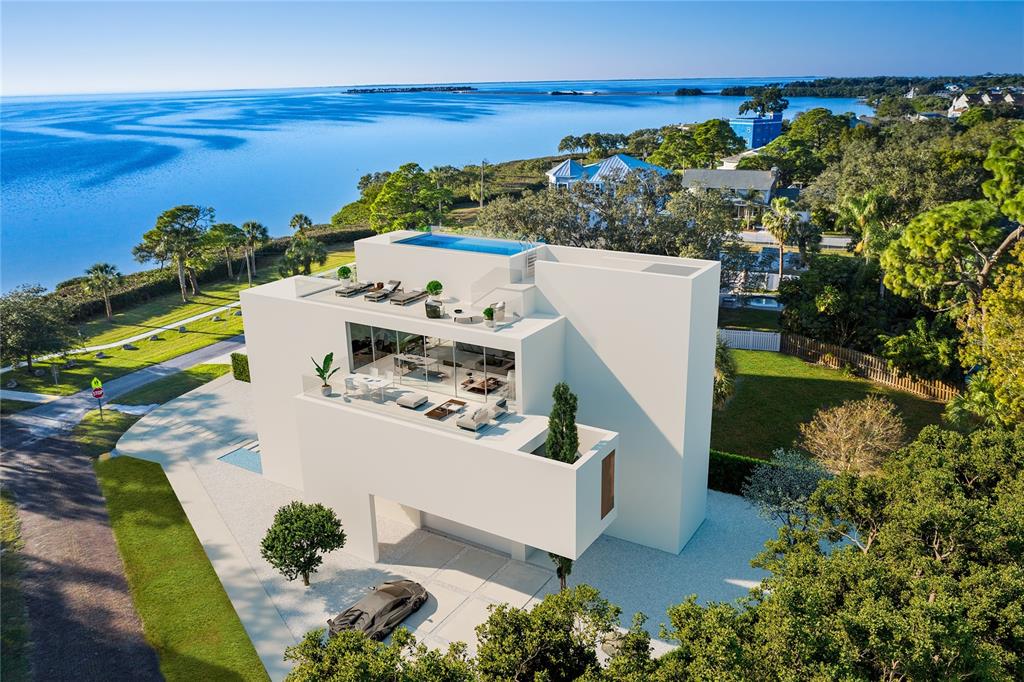 an aerial view of a house with a swimming pool ocean and mountain view