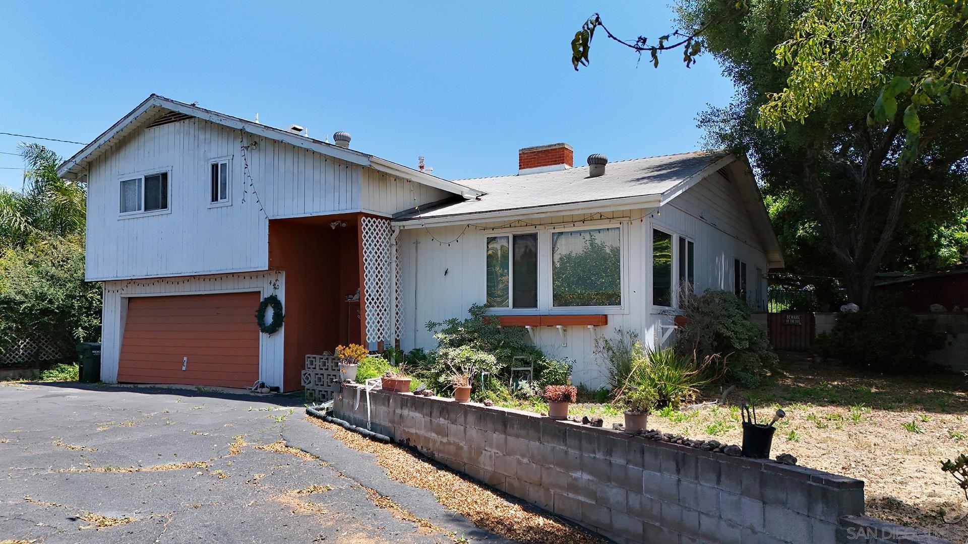 front view of a house with potted plants