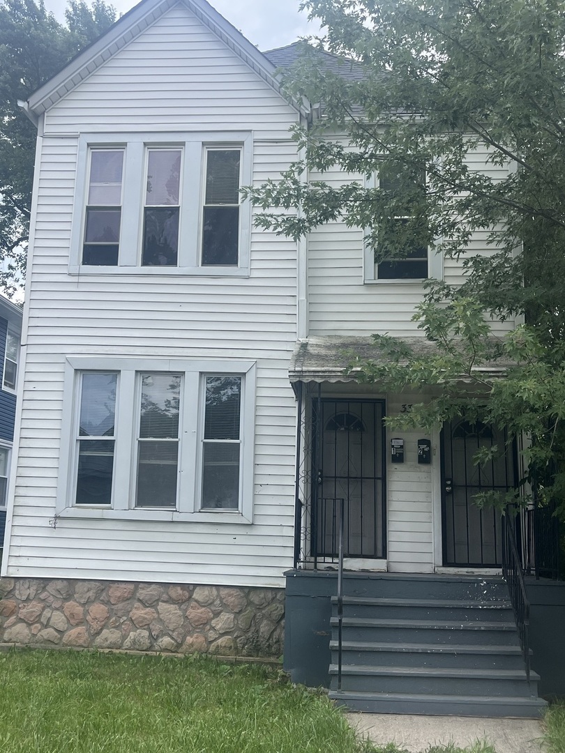 a front view of a house with a garden