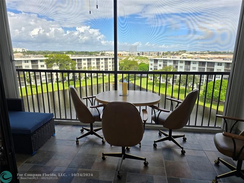 a view of a balcony with chairs