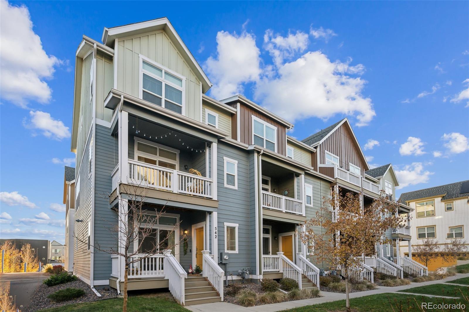 a front view of a residential apartment building with a yard