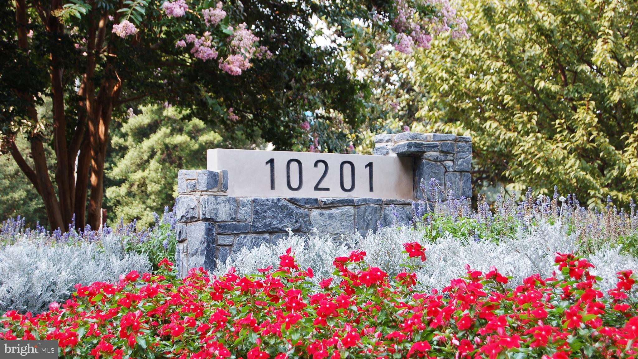 a sign that is in front of flowers