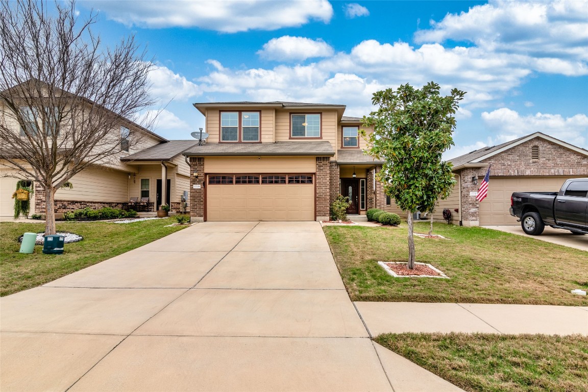 a front view of a house with a yard