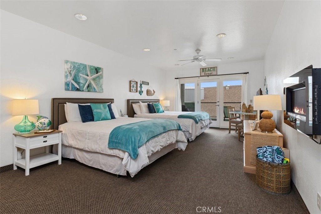 a bedroom with bed a chandelier and a couch