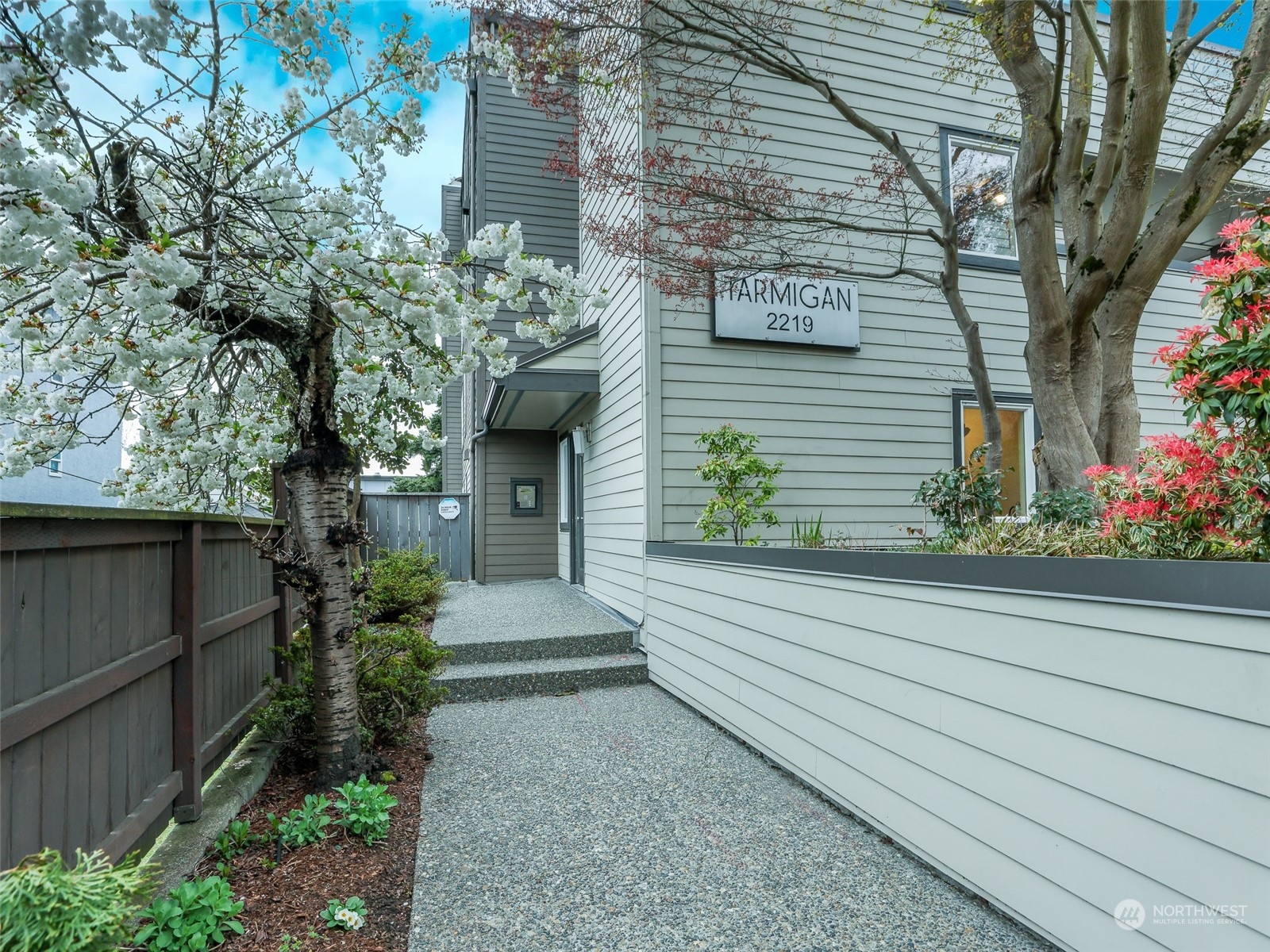 a front view of a house with plants