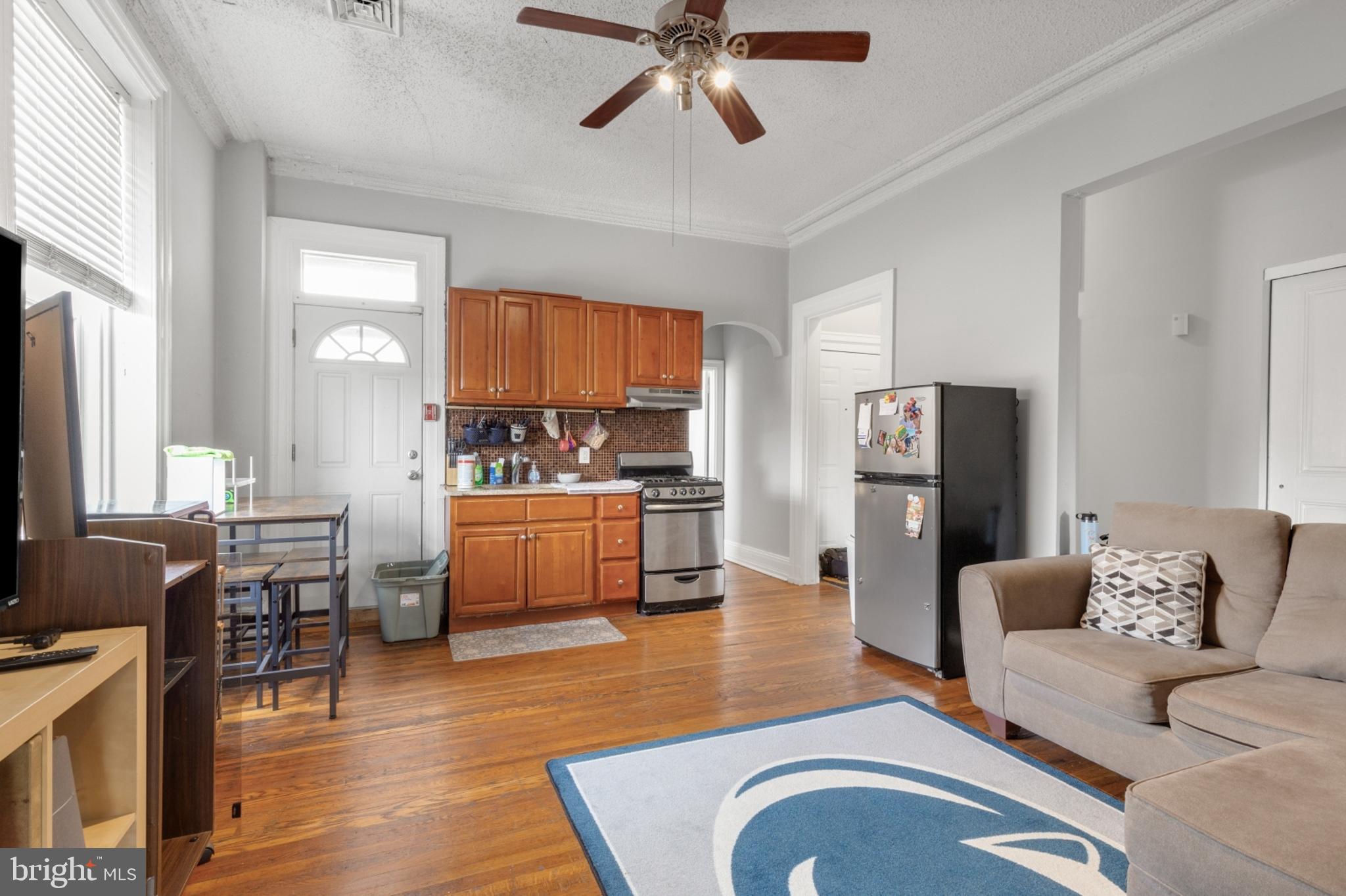 a living room with furniture and kitchen view