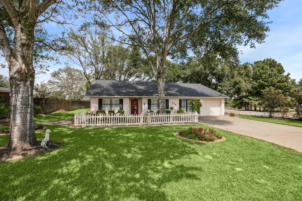 a front view of a house with yard patio and green space