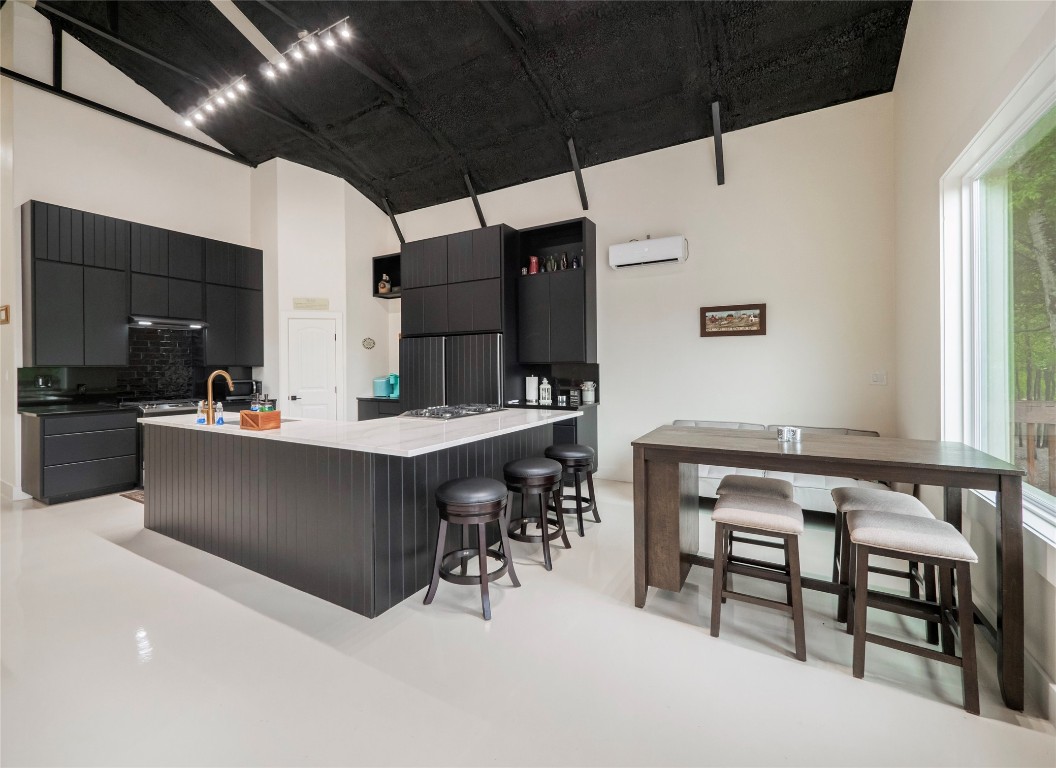 a kitchen with a table chairs sink and cabinets