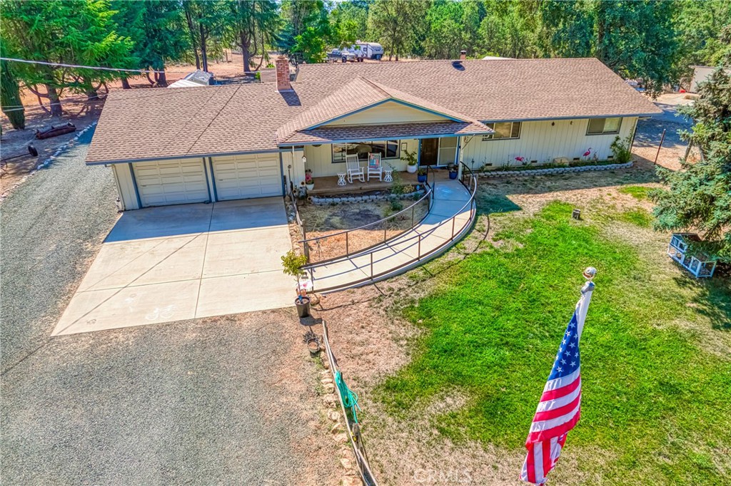 a aerial view of a house with swimming pool and sitting area