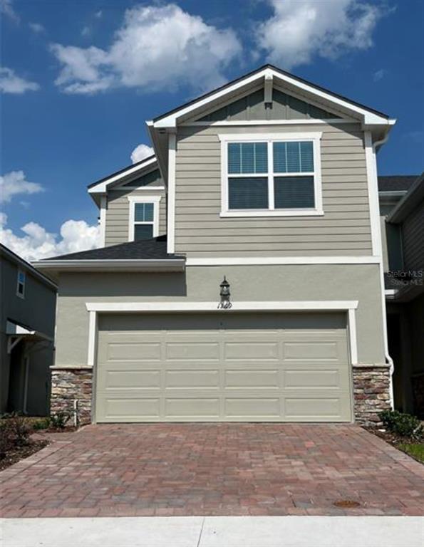 a front view of a house with garage