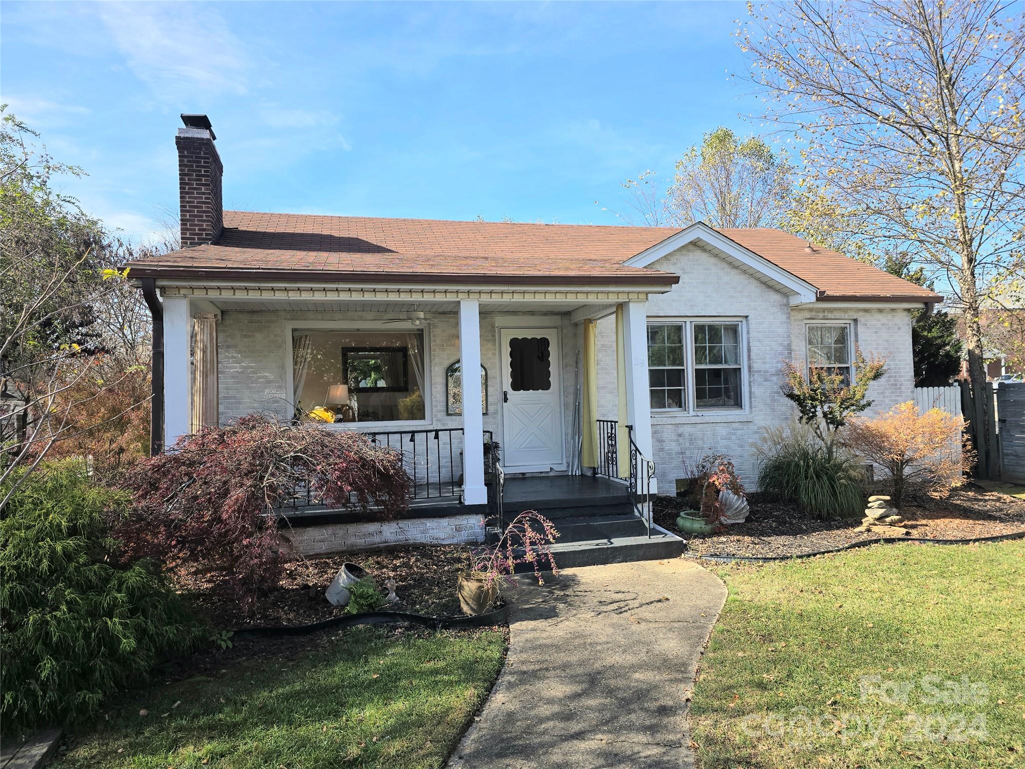 a front view of a house with a garden and patio