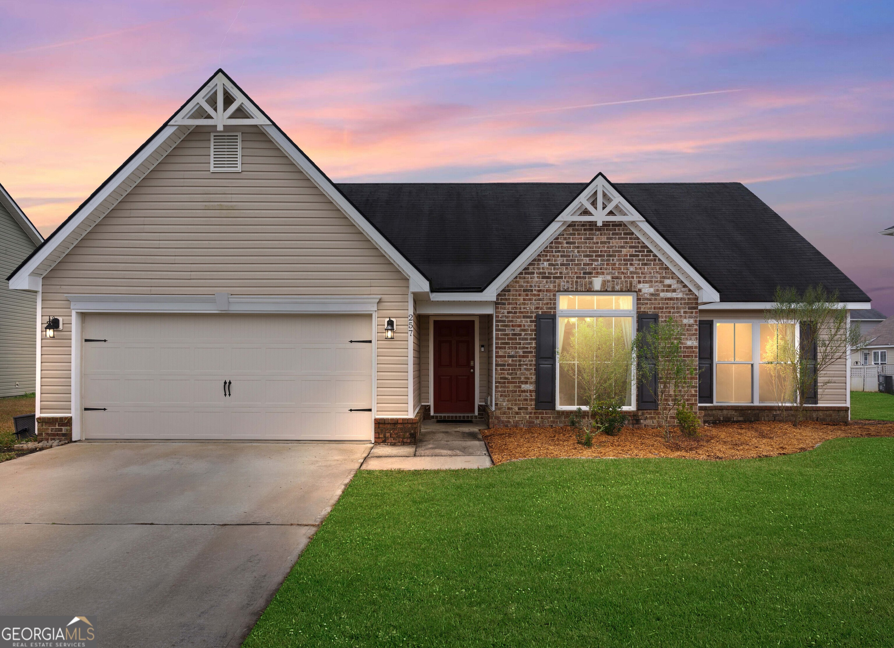 a front view of house with yard and green space