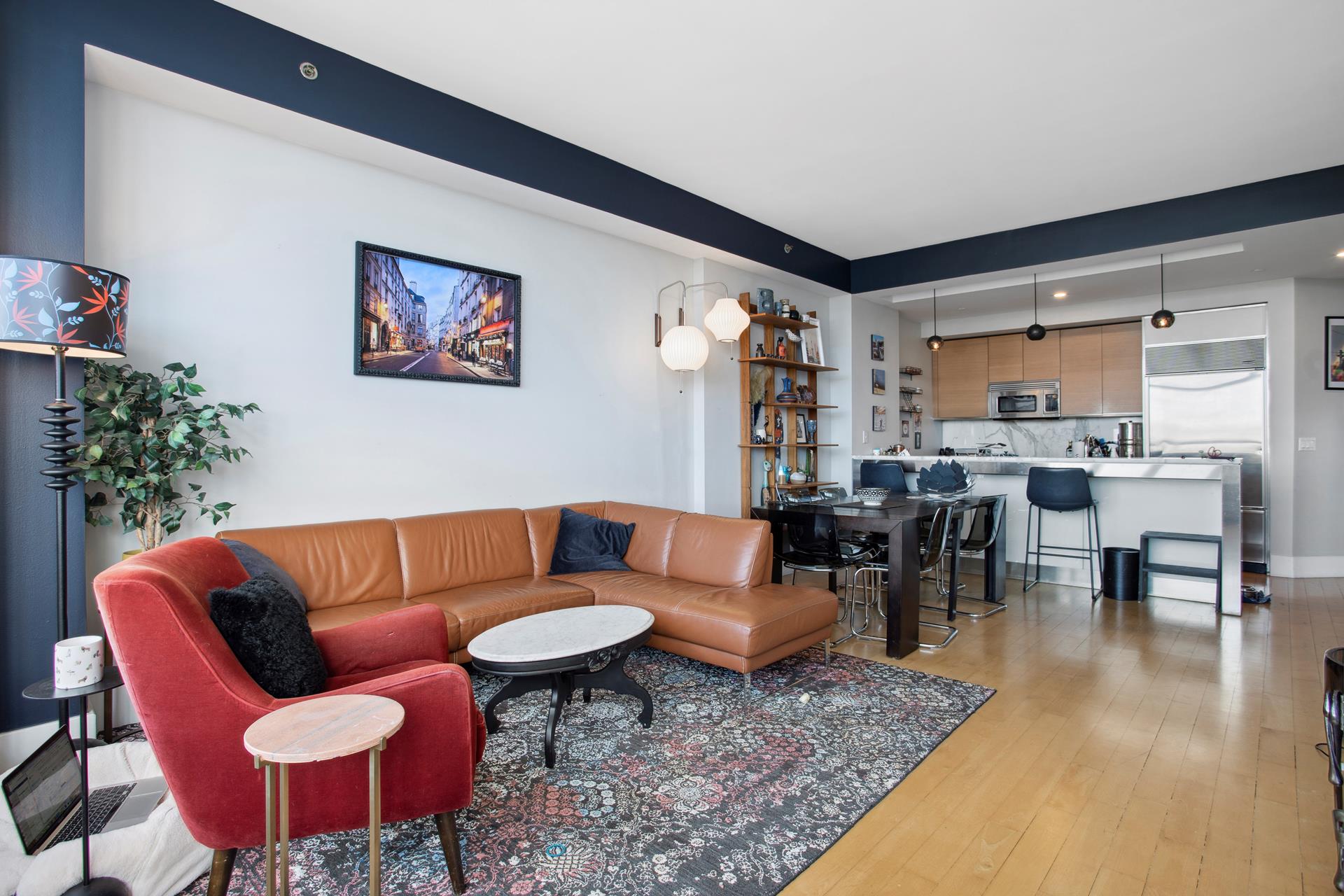 a living room with furniture a rug and a table